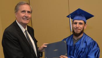 Christian Rodriguez receives his High School Equivalency from SCC's President, Dr. Don Tomas