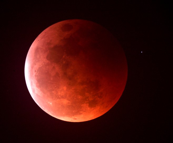 A red tinged Moon as seen during a total lunar eclipse.