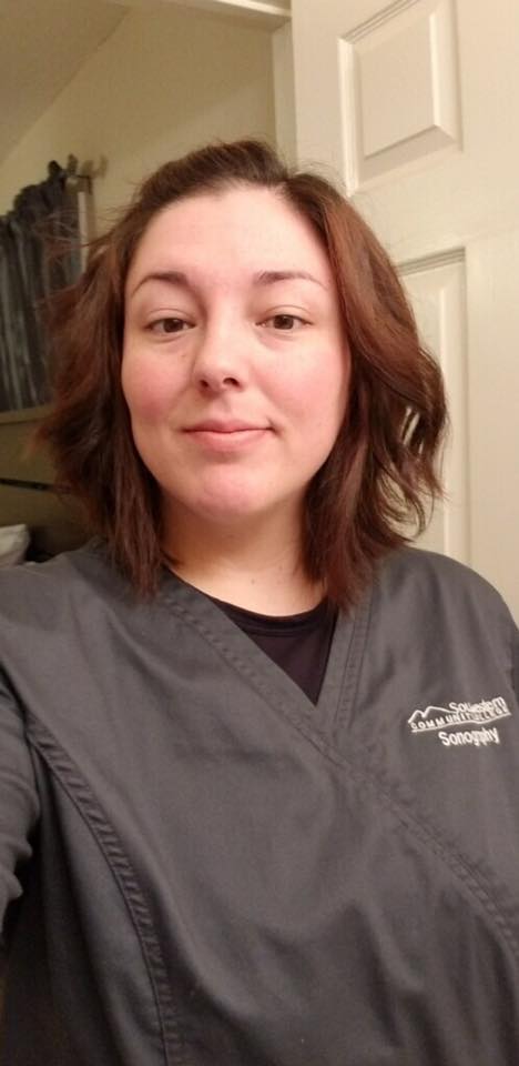 Young woman standing in sonography scrubs
