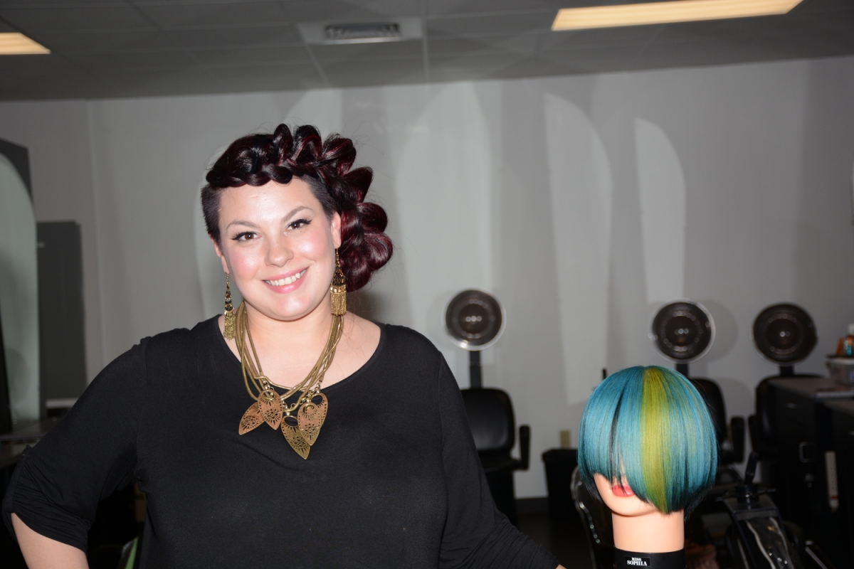 SCC graduate Cynthia Laws is shown with a cosmetology mannequin she used for a recent demonstration at the college.