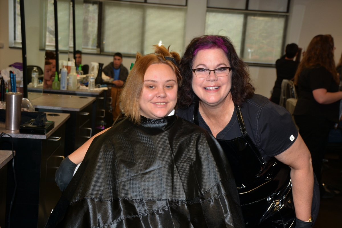 Bianca Dardeen (left), a participant in the Mother Town Healing Project, poses with her stylist, SCC Cosmetology student Lisa Vaccaro of Franklin.