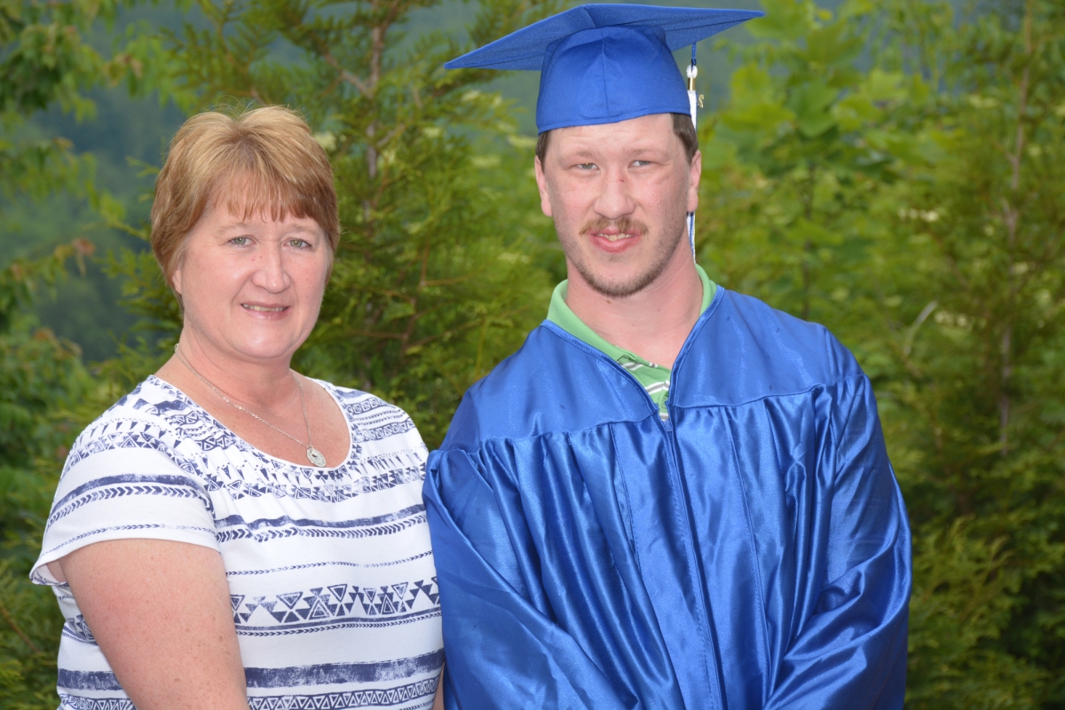 Mother and son standing with diploma