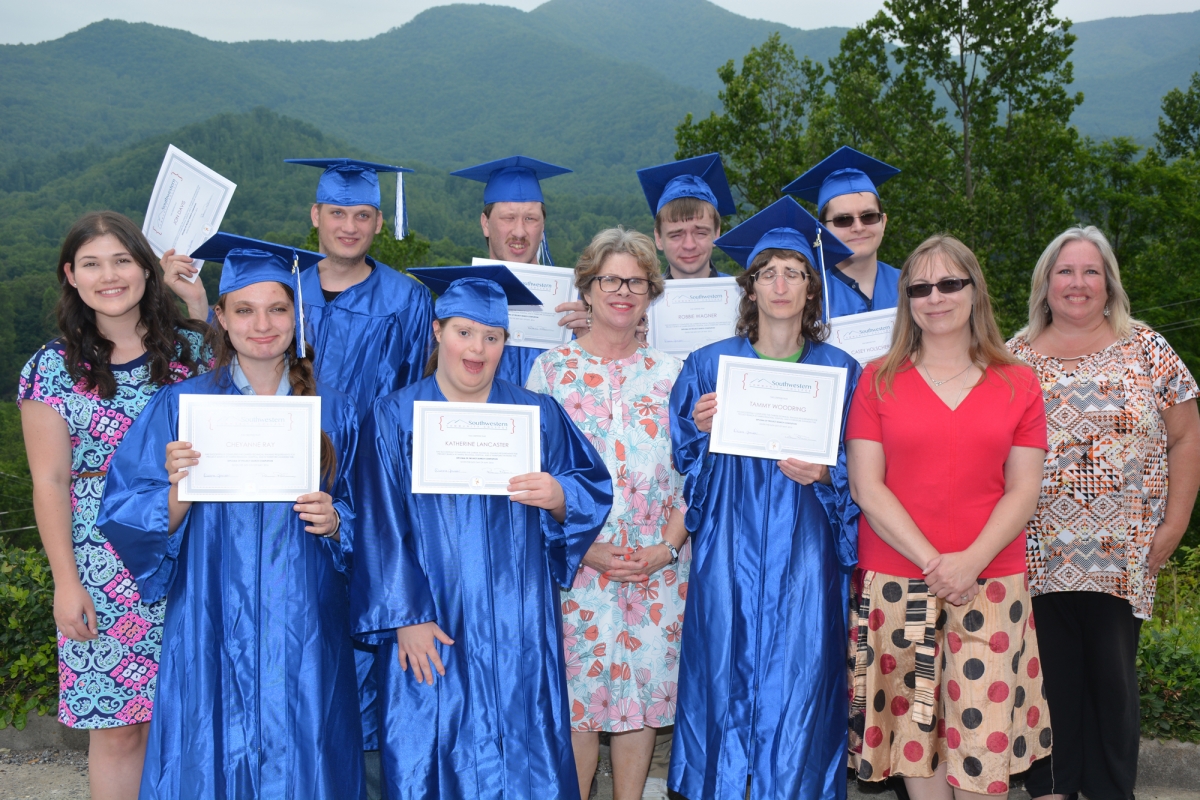 Group of students holding their diplomas