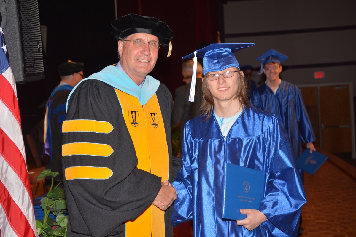 Photo of student receiving a diploma from SCC's president.