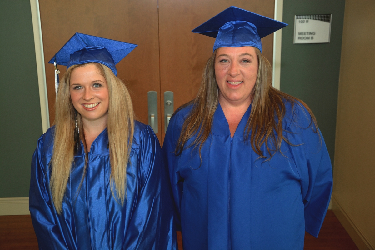 Two graduates wearing caps and gowns