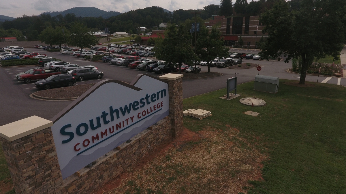 A new sign is pictured with a scene of campus behind it.