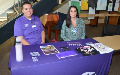 Man and woman sit at a recruiting table inside the Groves Center on SCC's Macon Campus