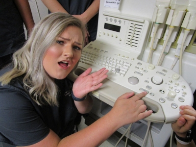 Student shows off the program's current ultrasound machine