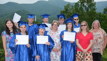 Group of students holding their diplomas