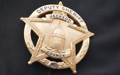 Jackson County Deputy Sheriff badge, gold in shape of a star.