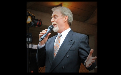Man sings into a microphone.