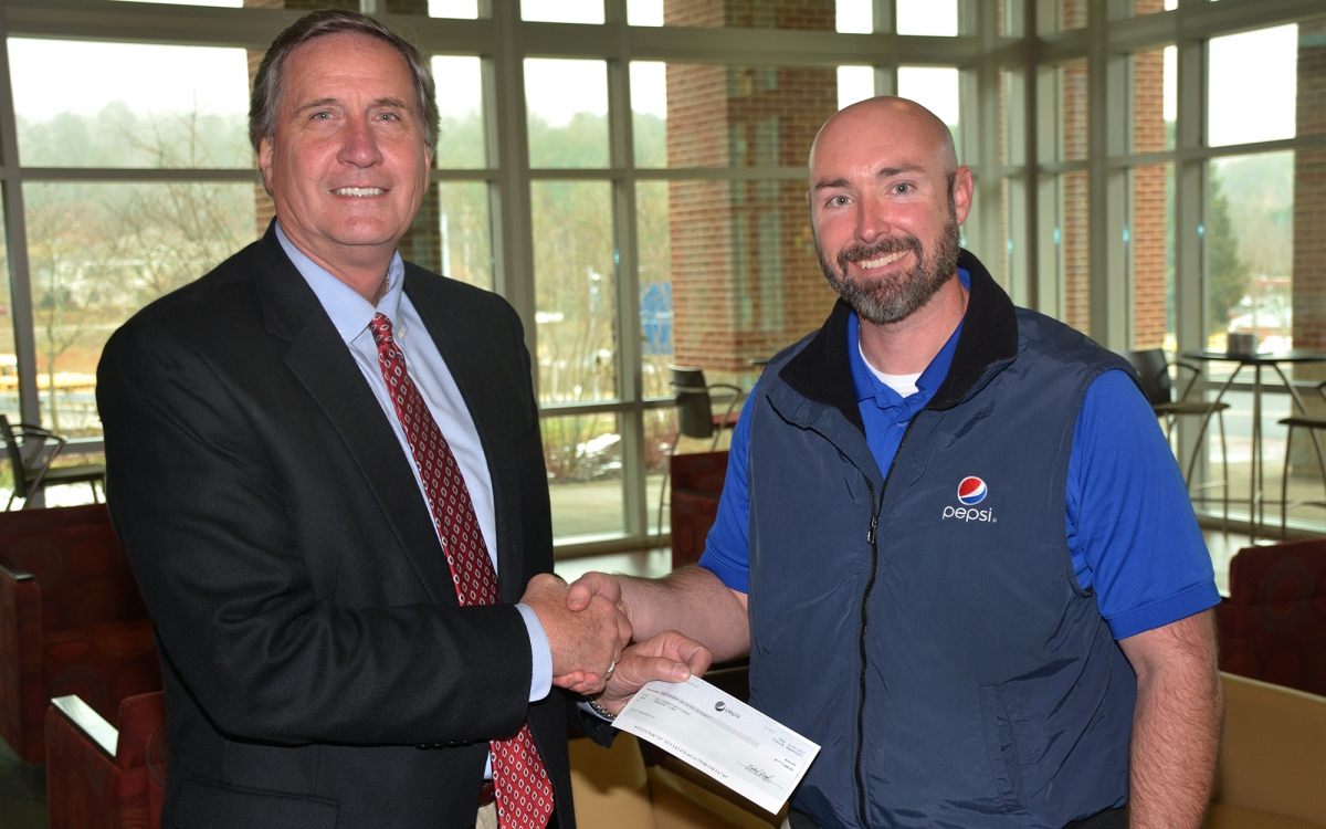 SCC president Dr. Don Tomas and Travis Ashe of Pepsi pictured at SCC.