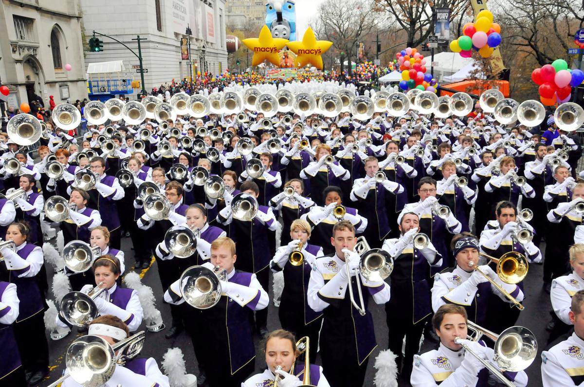 The WCU Marching Band dressed in purple and white leading the Macy's Thanksgiving Day Parade.