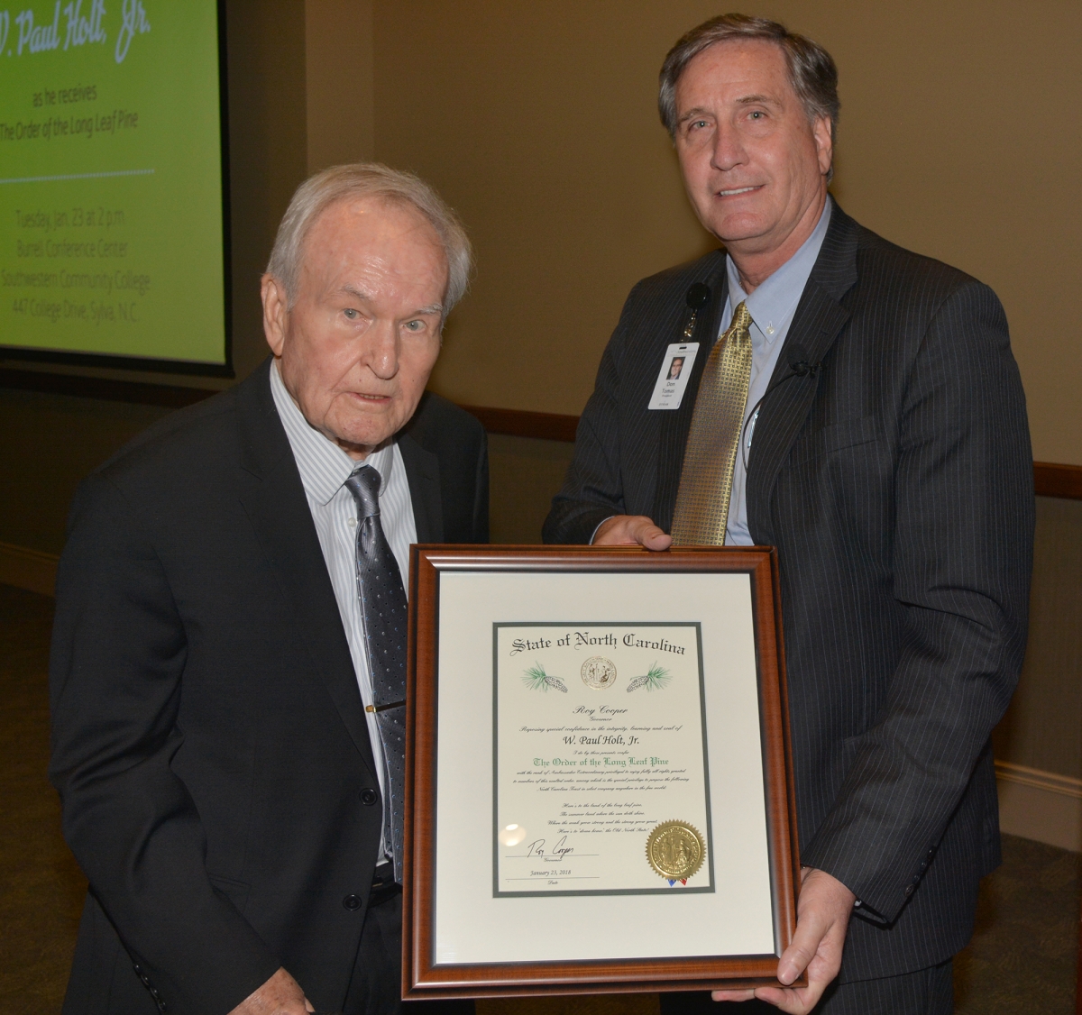 SCC trustee Paul Holt and SCC president Dr. Don Tomas holding award.