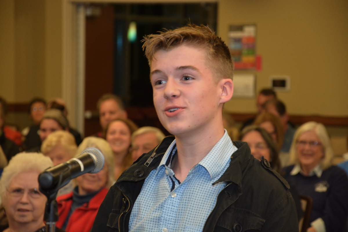 Young man speaks into a microphone