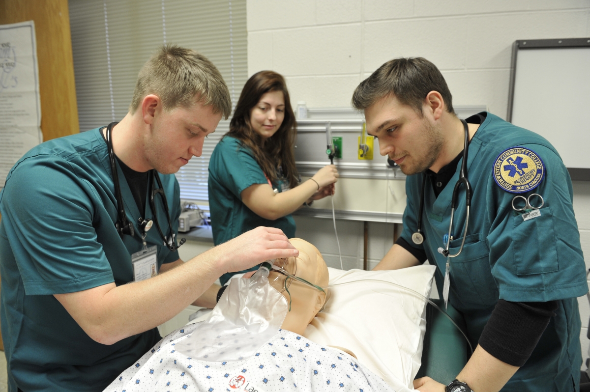 Photo of three students working with respiratory equipment