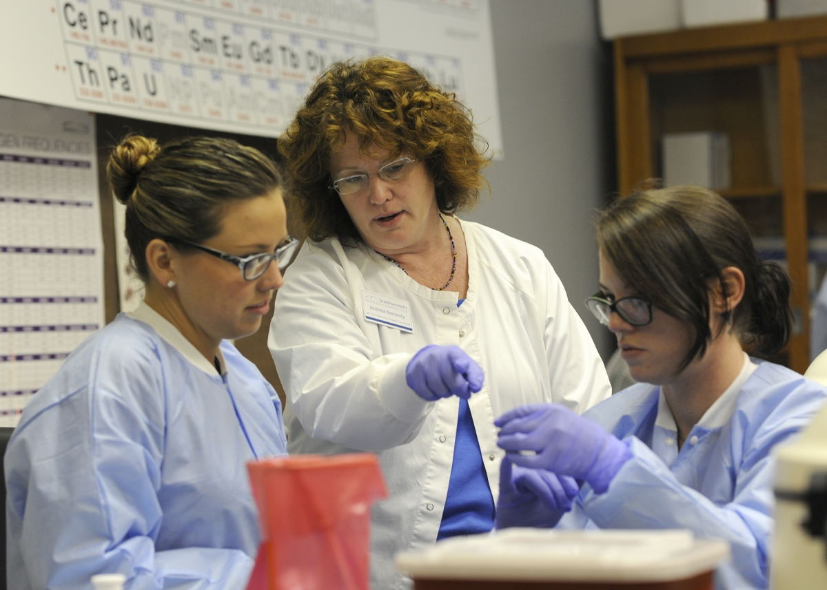 Female instructor works with two female students in SCC's lab.