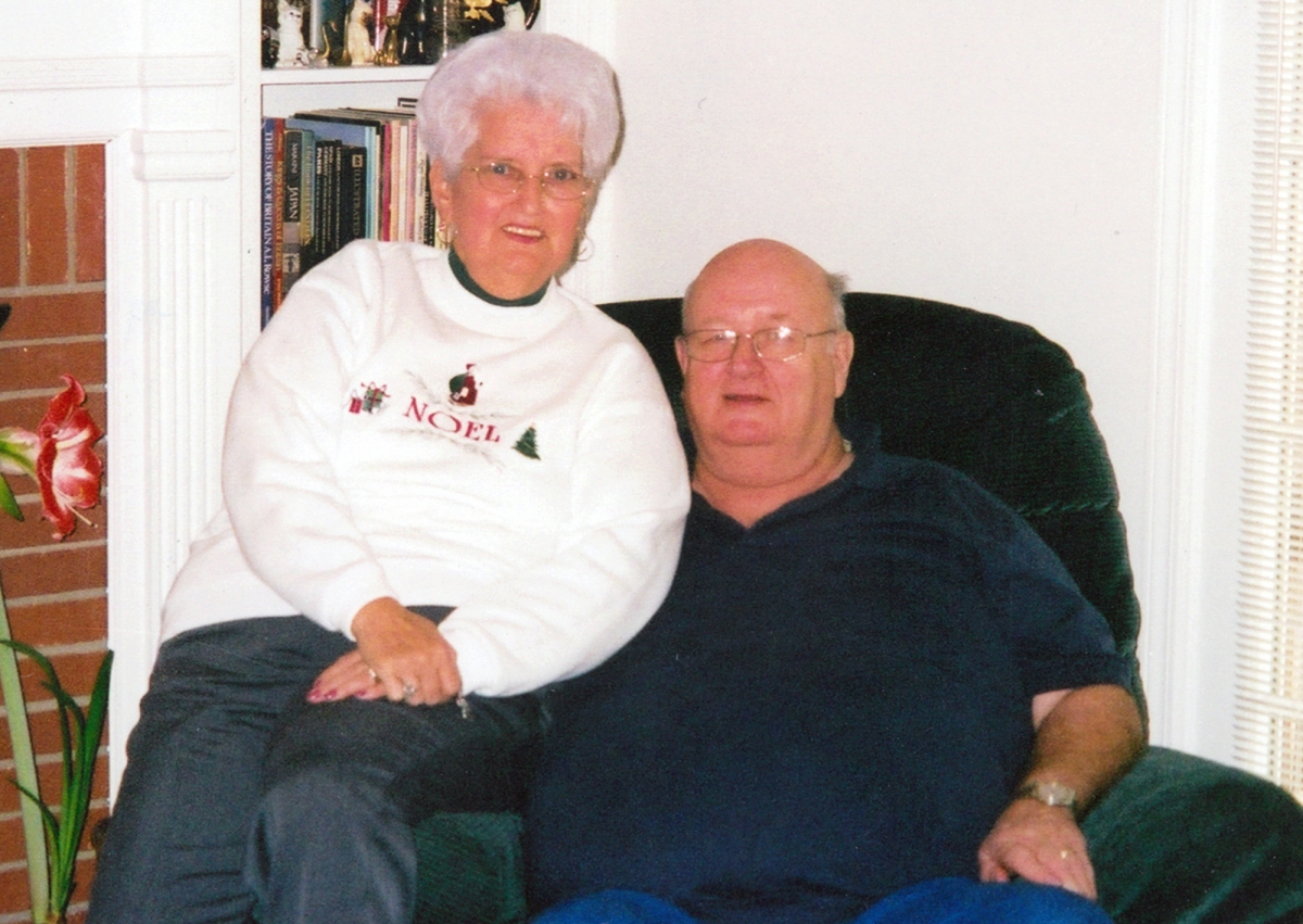 Couple poses for a photo inside their home