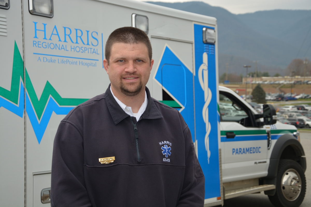 Man stands in front of an ambulance