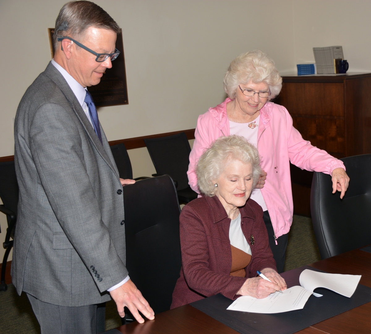 Doreyl Ammons Cain signs paperwork to establish a scholarship.