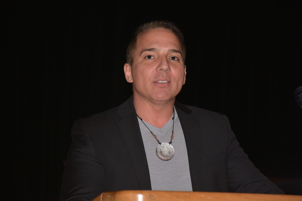 Man speaks from a podium