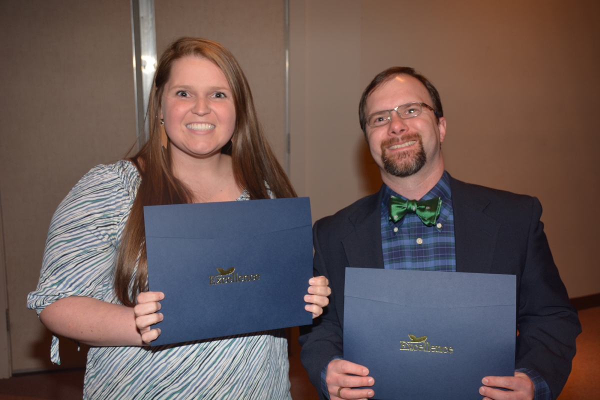 Group of students hold up their award certificates