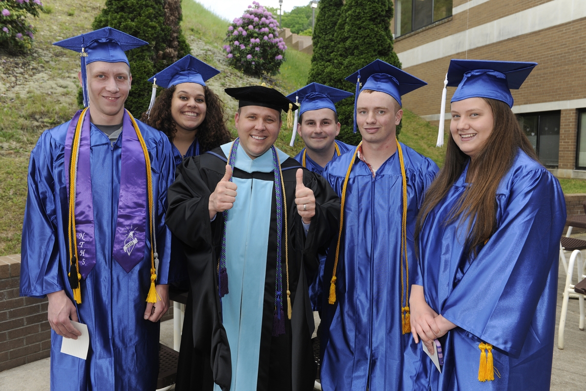 Students standing and smiling 