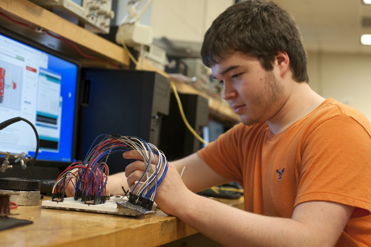 Student looking at wires