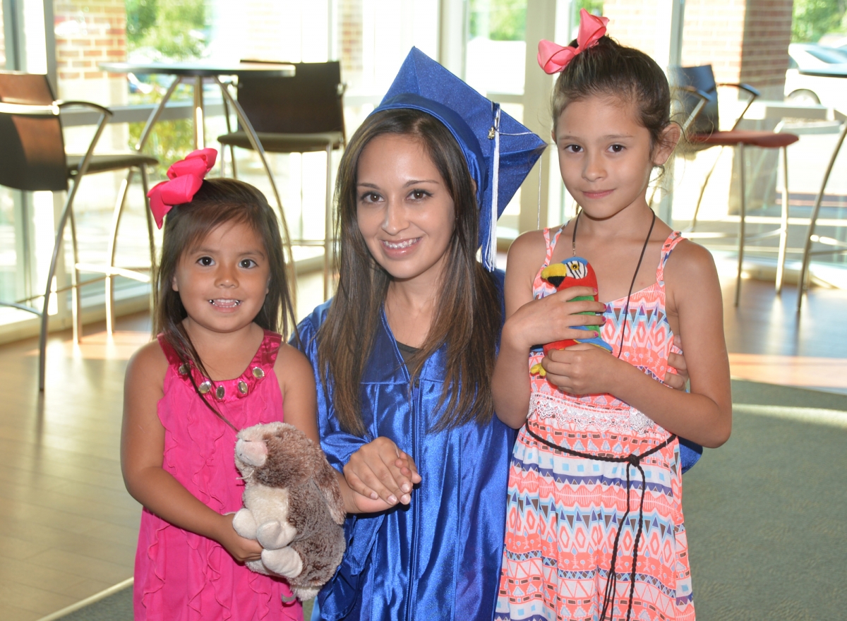 Yanez smiling with her two children