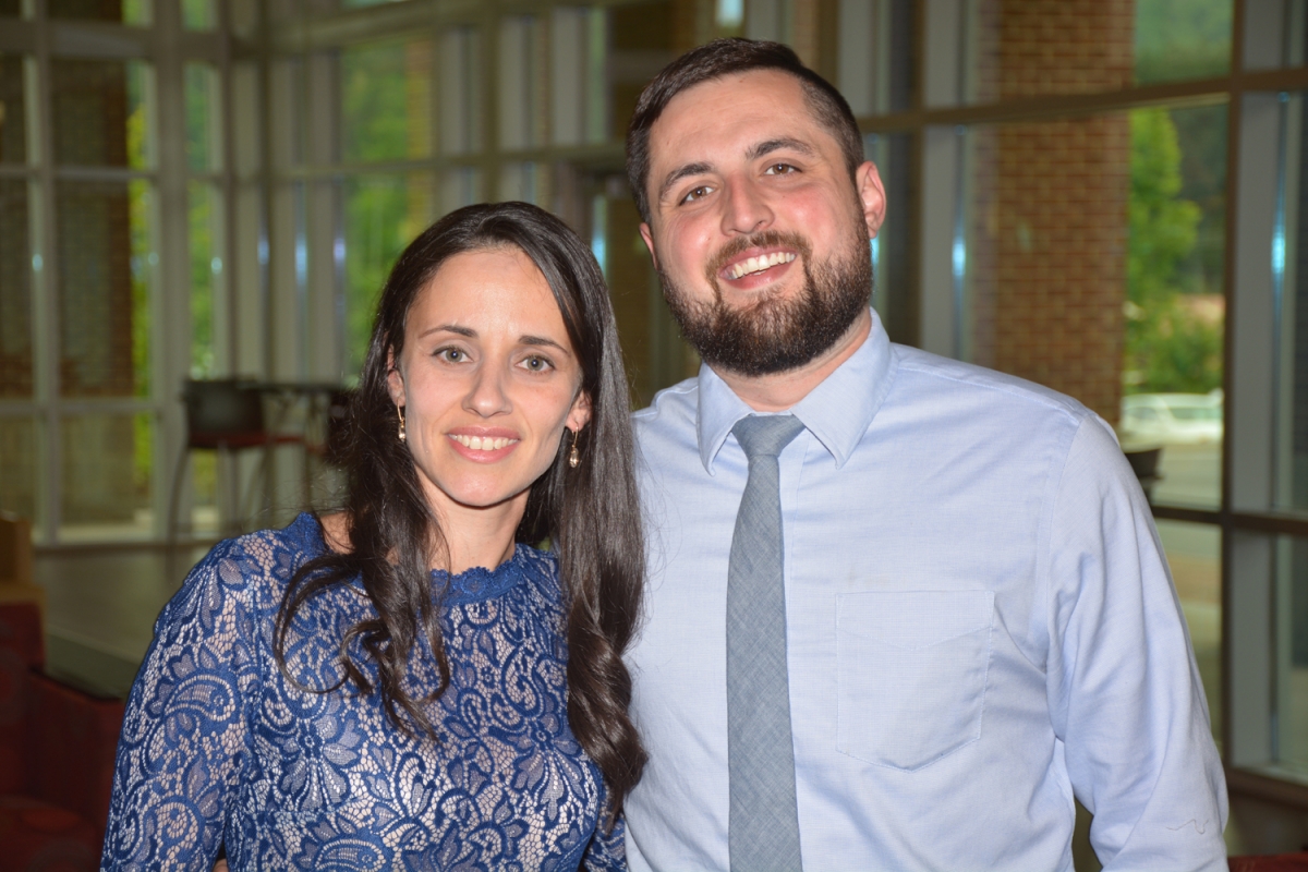 Man and woman standing and smiling 