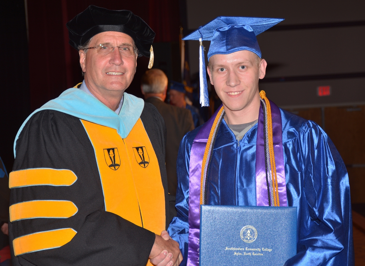 Photo of student receiving diploma from SCC's president.