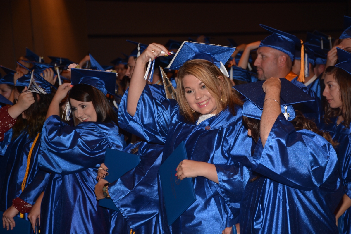 Graduates move their tassels on their graduation caps at the end of the commencement ceremony in Sylva.