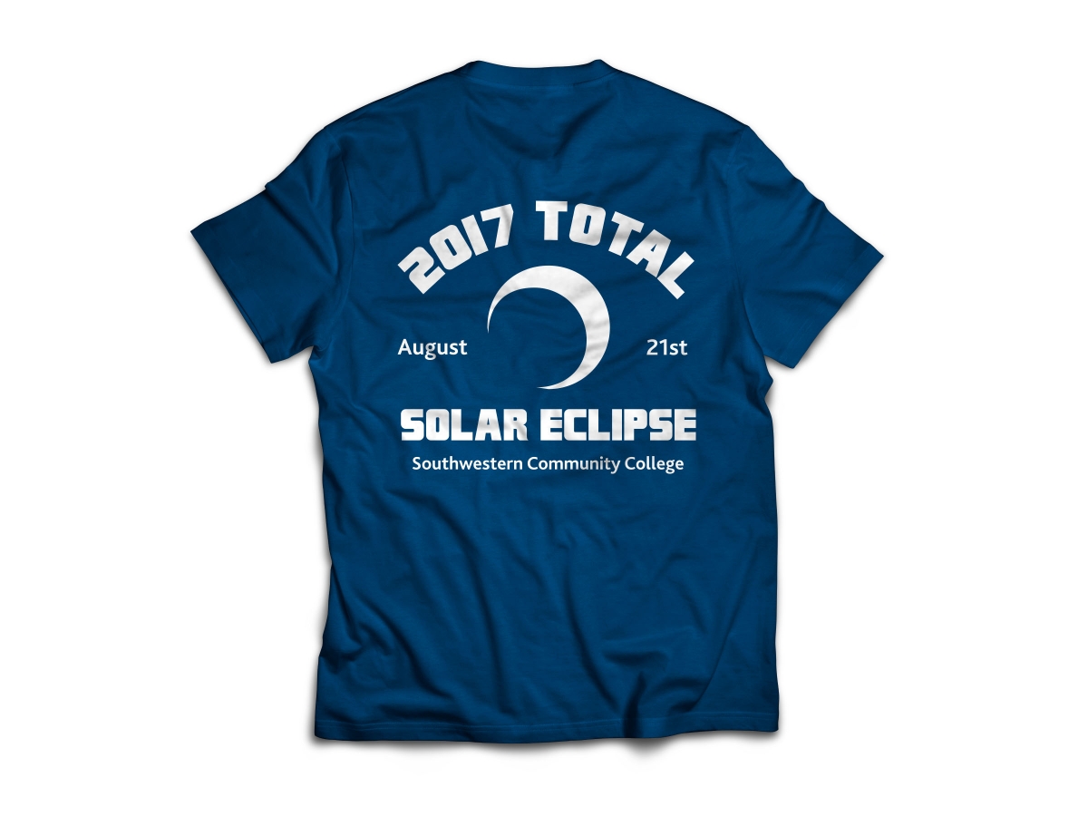 Photo of blue SCC eclipse t-shirt with white text and graphics