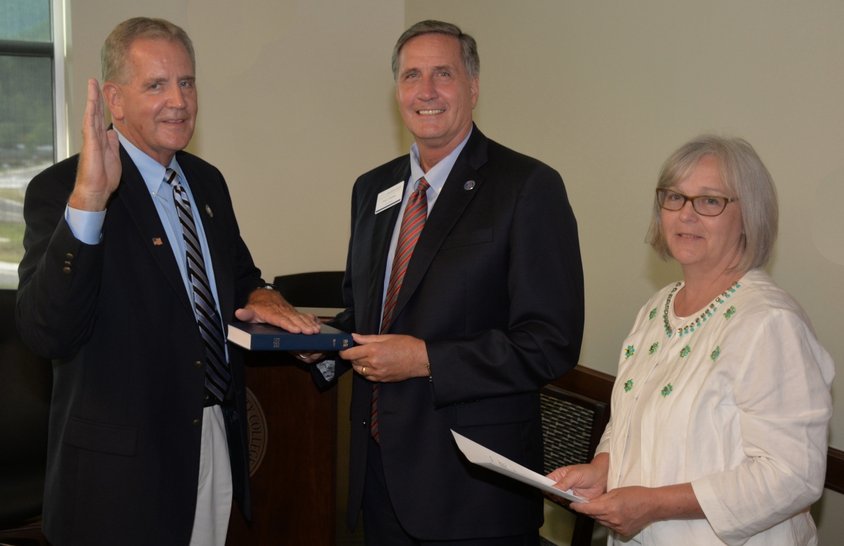 Gary Shields is pictured with his hand on a bible while being sworn in.