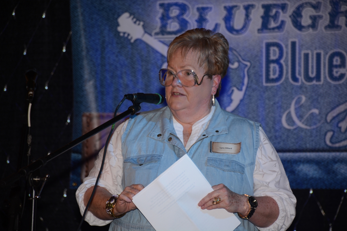 Photo of Dr. Lynn Dillard speaking at a microphone.