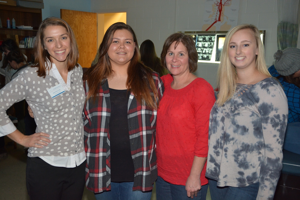 Two female students and two female instructors pose for a photo inside SCC's medical sonography lab.