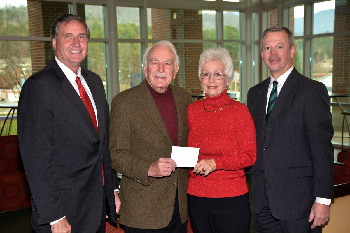 Three men and a woman pose for a photo inside a building on SCC's Jackson Campus.