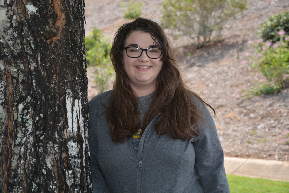 Young lady poses near a tree on SCC's Jackson Campus