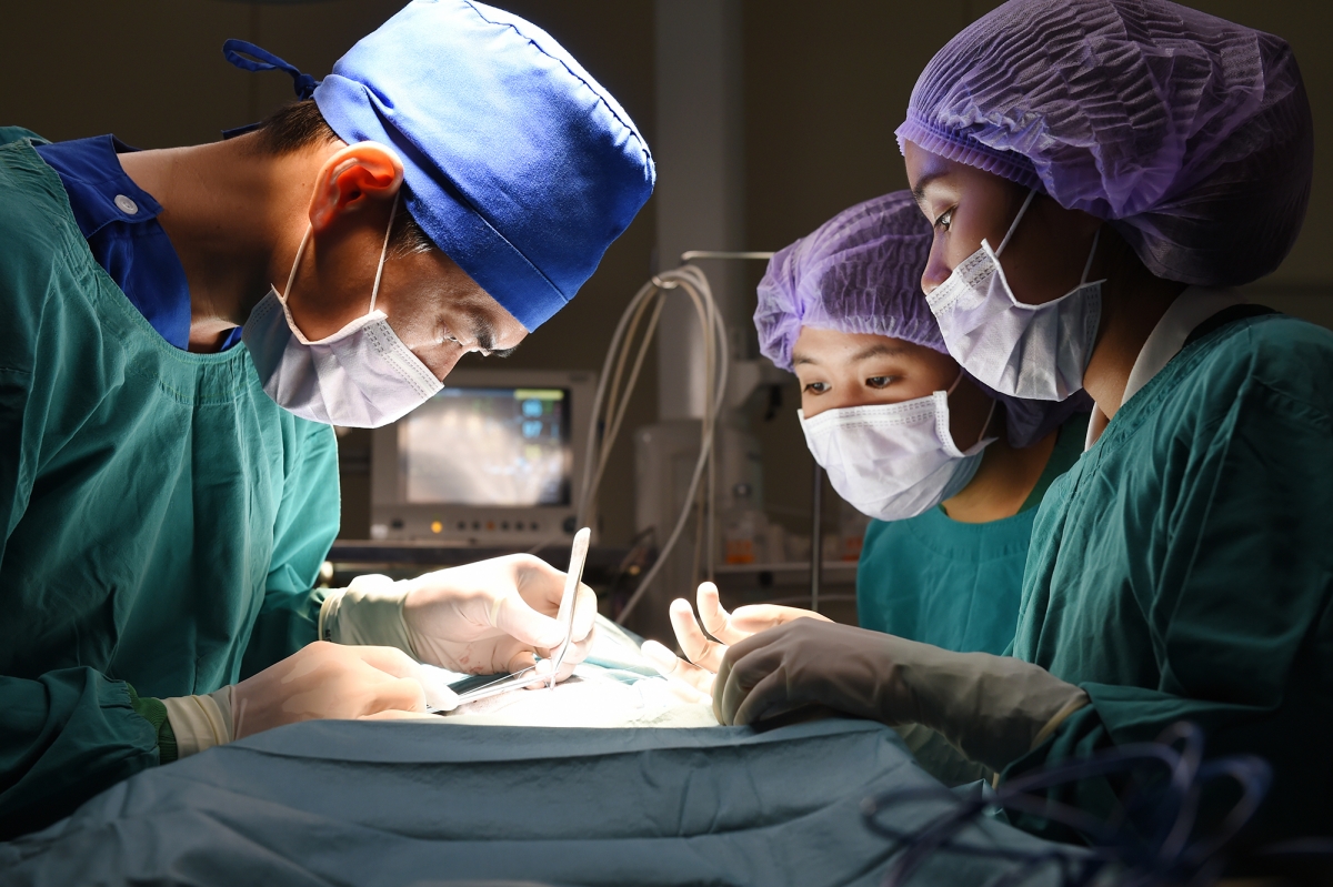 Surgeon and Surgical Technician work together in an operating room.