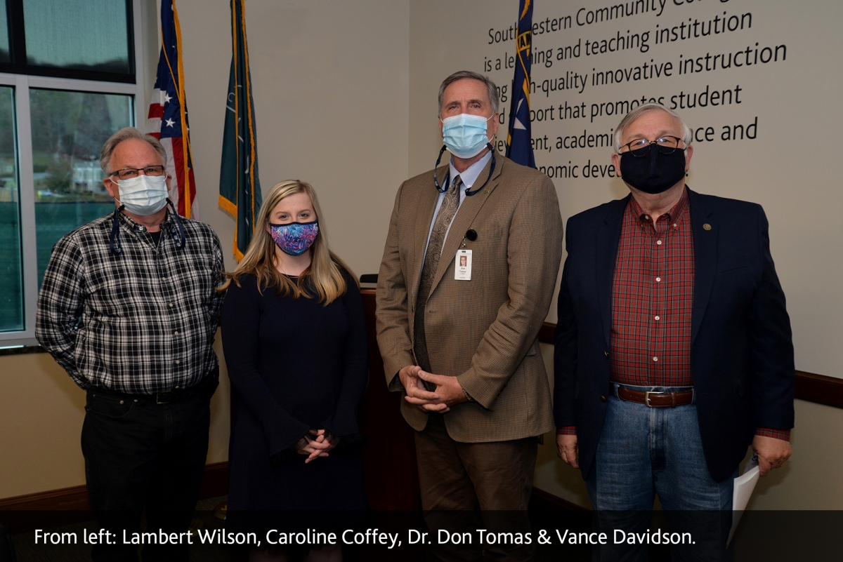 Caroline Coffey, student representative, stands beside Lambert Wilson, Dr. Don Tomas and Vance Davidson.