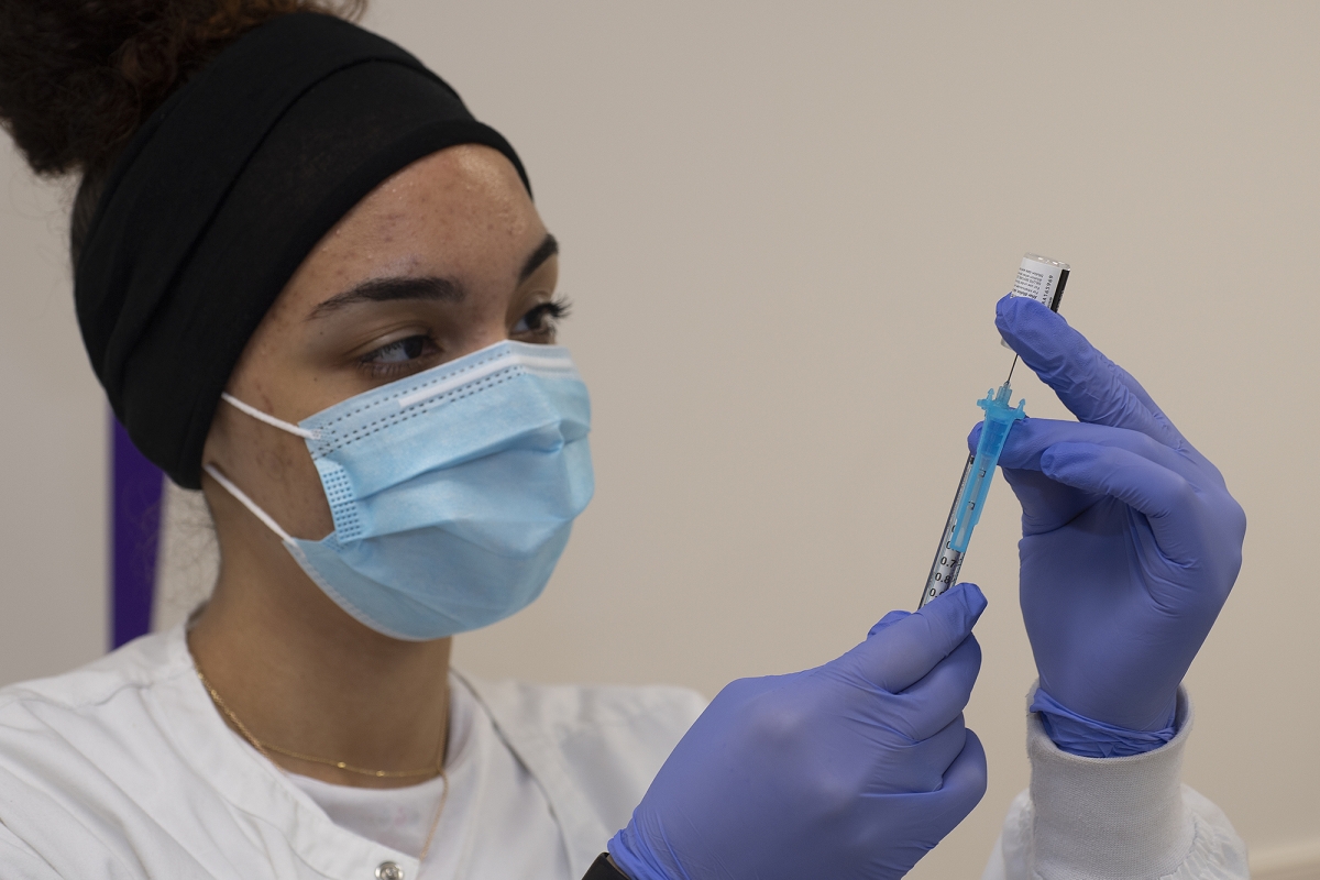 SCC Nursing student Brittany Gardner draws COVID-19 vaccine into a syringe at WCU’s COVID-19 vaccination clinic on March 15 in Cullowhee.