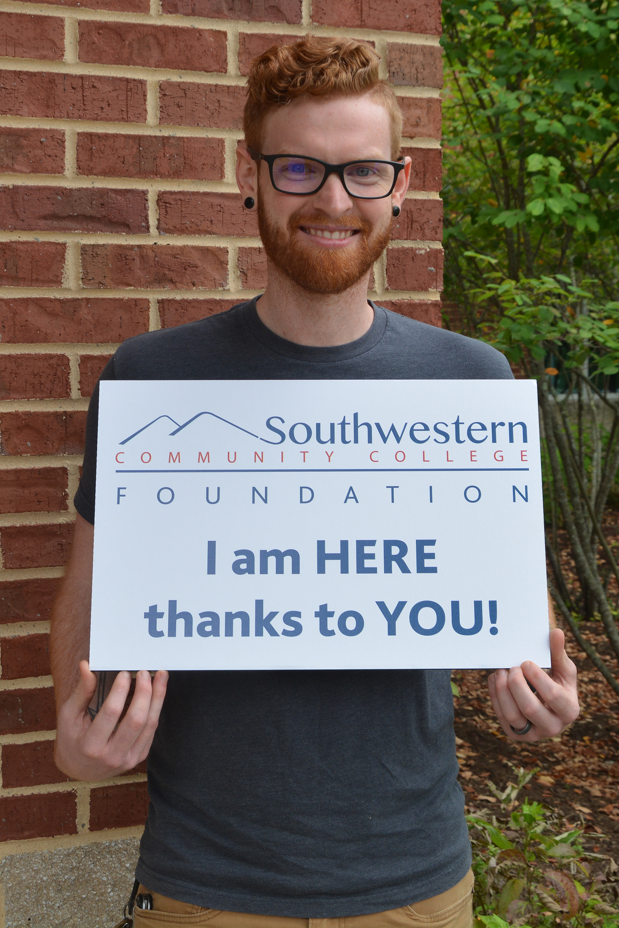 Young man holds 'Thank You' sign