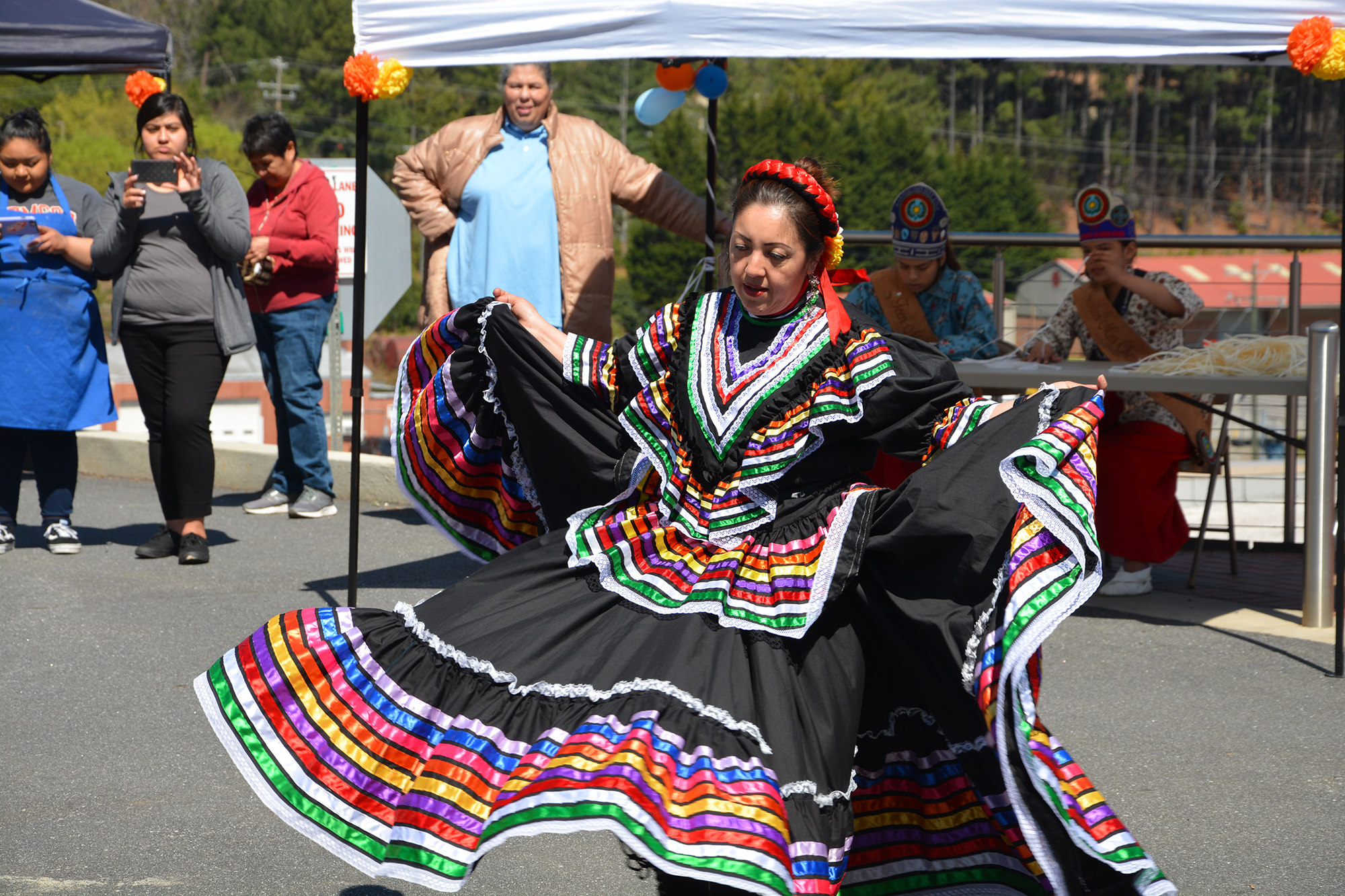 Woman in colorful dress performs a traditional dance