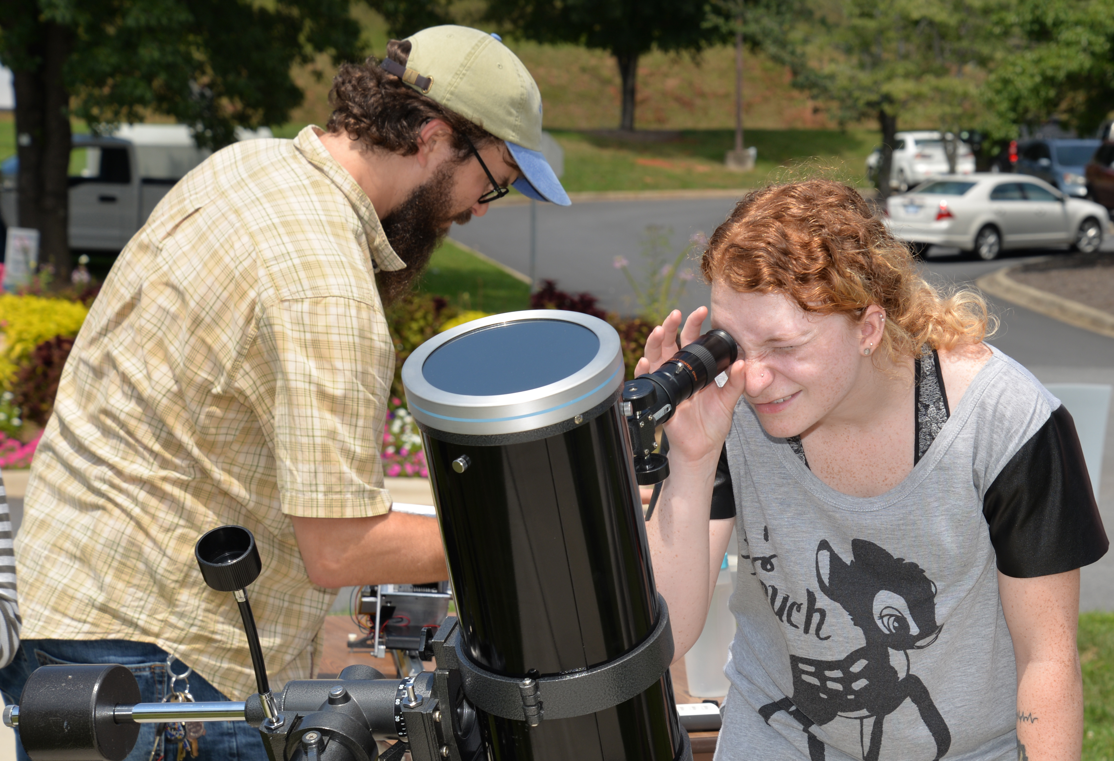 Young lady looks through a telescope during the 2017 total solar eclipse