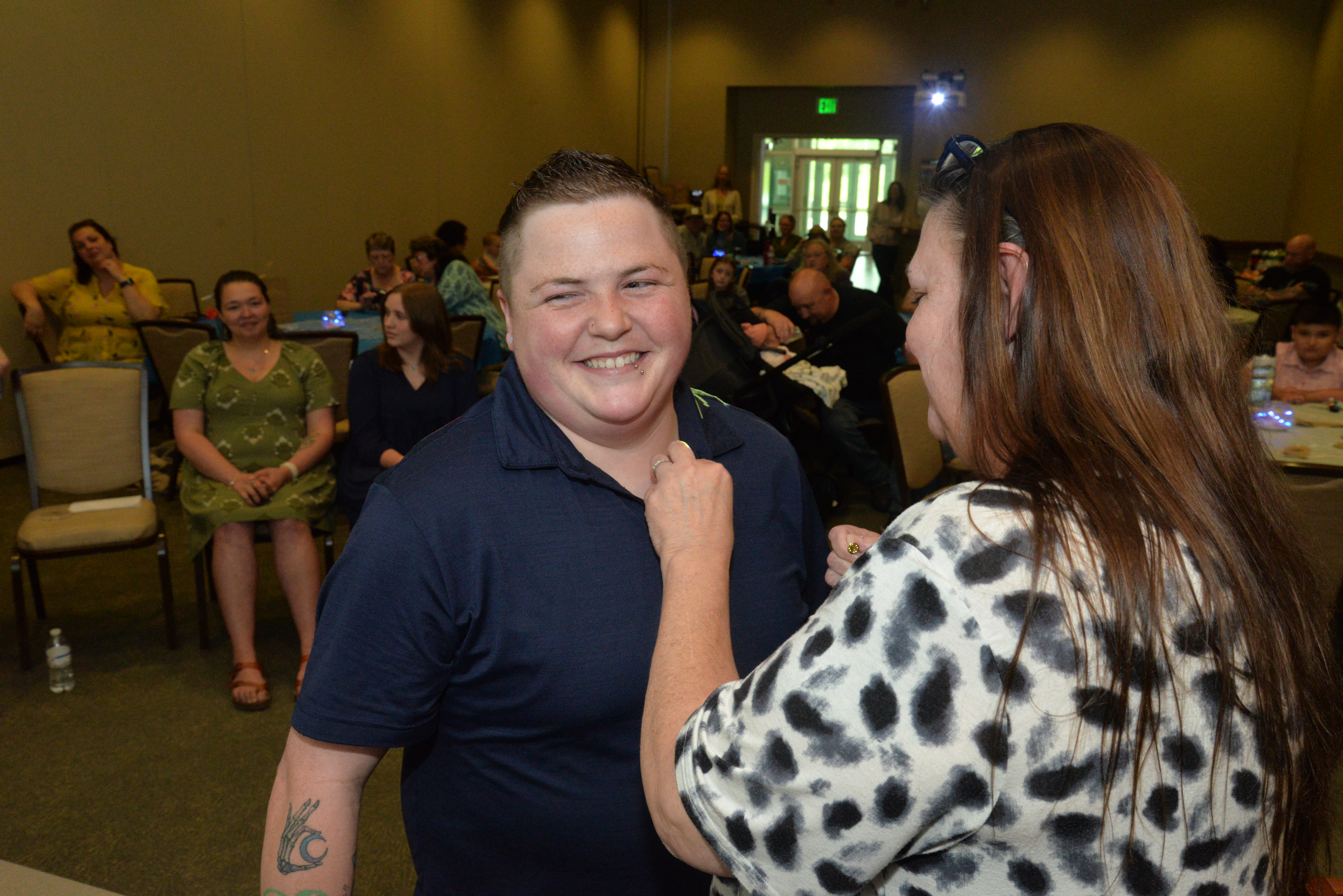Brittany Martin receives her pin from program coordinator Crystal Rhynes