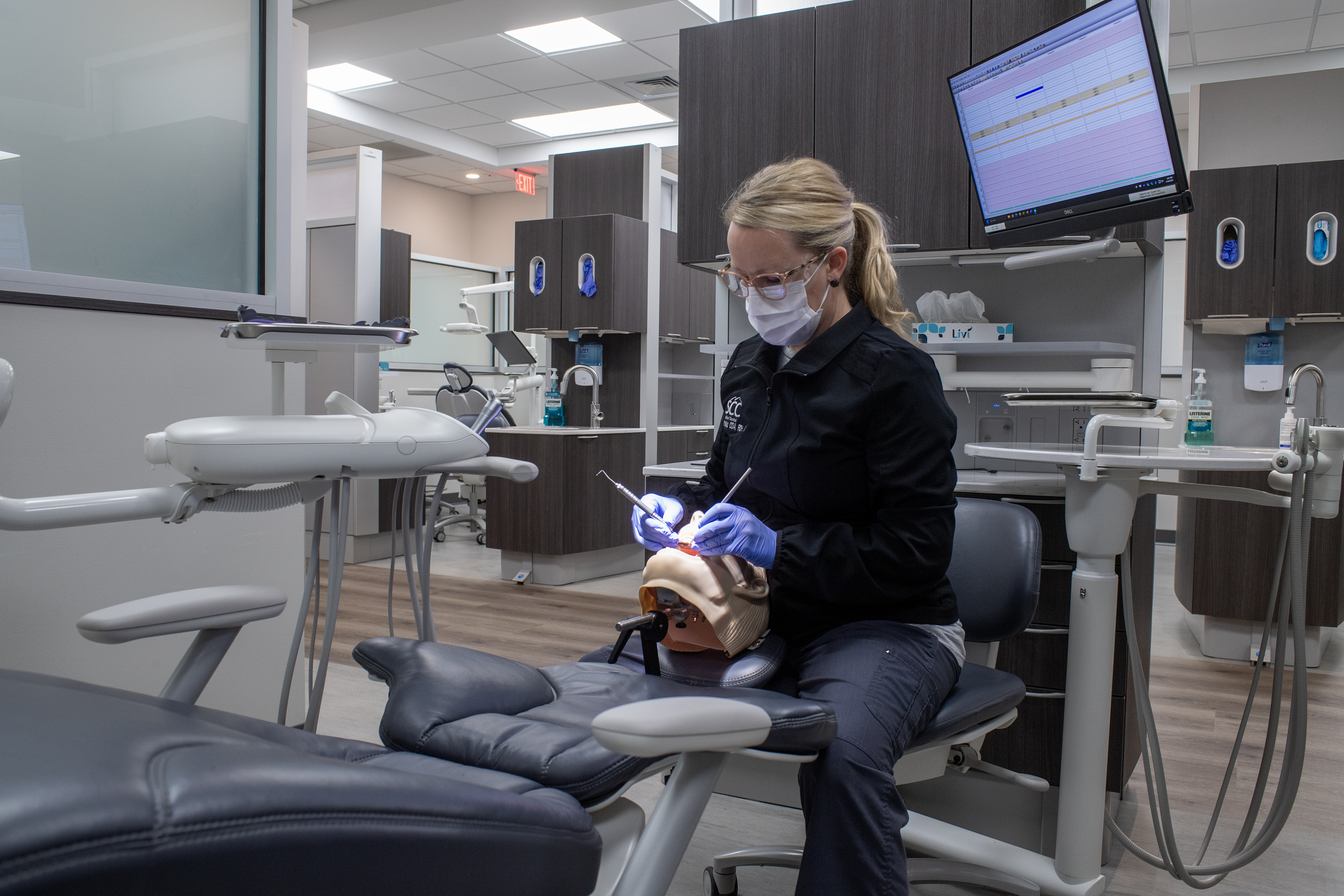 Woman works on sim manekin