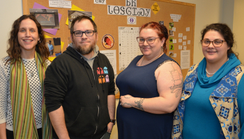 Three ladies stand beside a male SCC student inside a building on WCU's campus.