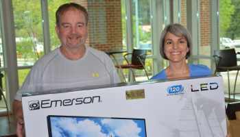 Gary Smith and Kathy Posey hold the 40-inch flatscreen TV Smith and his wife Karen recently won.