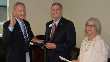 Gary Shields is pictured with his hand on a bible while being sworn in.