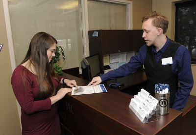 Man and woman look at paper.